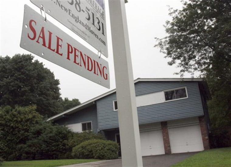 A sign announces a pending residential home sale in Wayland, Mass., this week. Fixed mortgage rates have fallen to record or near-record lows, but that has done little to boost housing sales. 